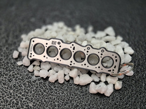 keychain - Schlüsselanhänger - Miniatur einer Kopfdichtung für VW/Volvo D24 / D24T - DisagrEE Germany