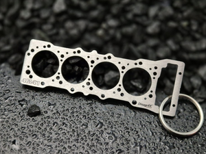 keychain - Schlüsselanhänger - Miniatur einer Kopfdichtung für Mitsubishi 4M41 / 4M42 - DisagrEE Germany