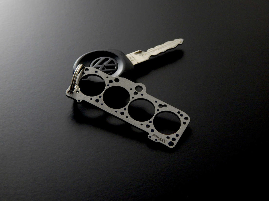 Miniatur einer Kopfdichtung für VAG 1,8-2,0 (EA827) - DisagrEE - keychain - Schlüsselanhänger